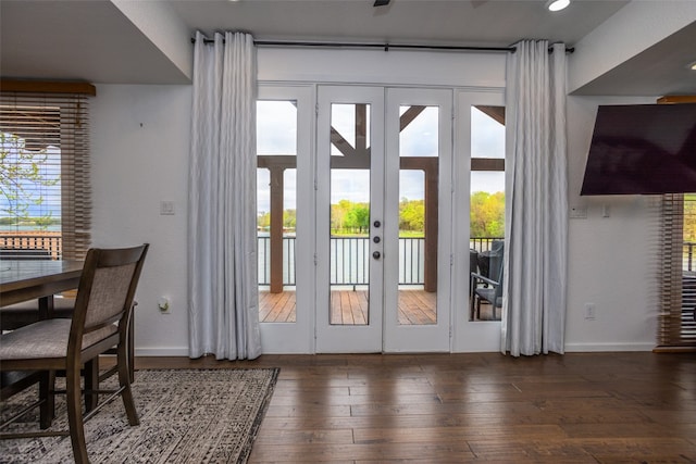 doorway with french doors and dark hardwood / wood-style flooring