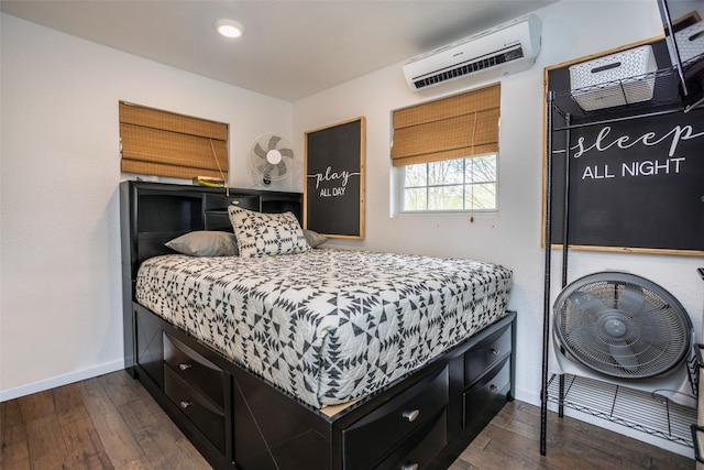 bedroom featuring dark hardwood / wood-style flooring and an AC wall unit