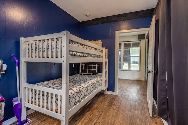 bedroom with dark hardwood / wood-style floors