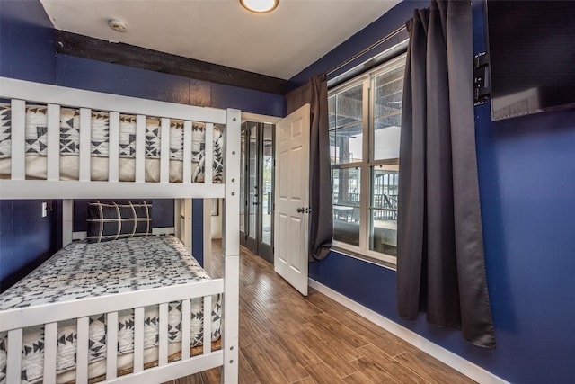 bedroom with french doors and dark hardwood / wood-style floors