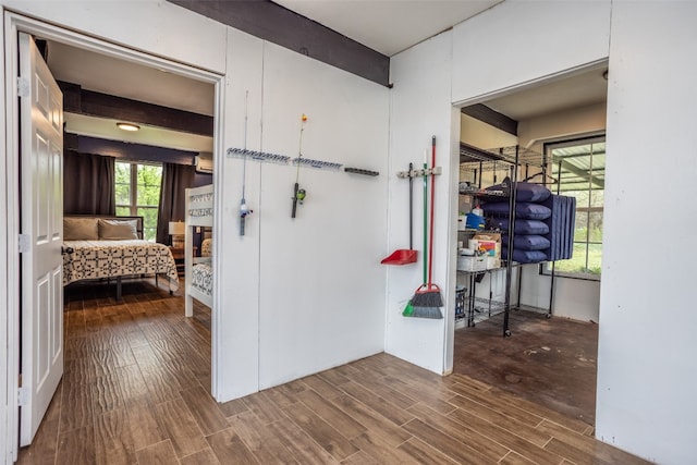 corridor featuring dark hardwood / wood-style floors and beamed ceiling