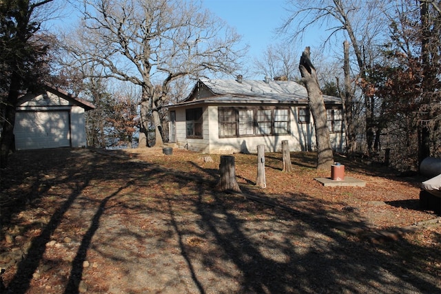 rear view of property featuring a garage