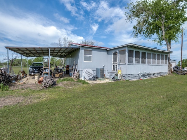 back of house with a lawn and central AC unit