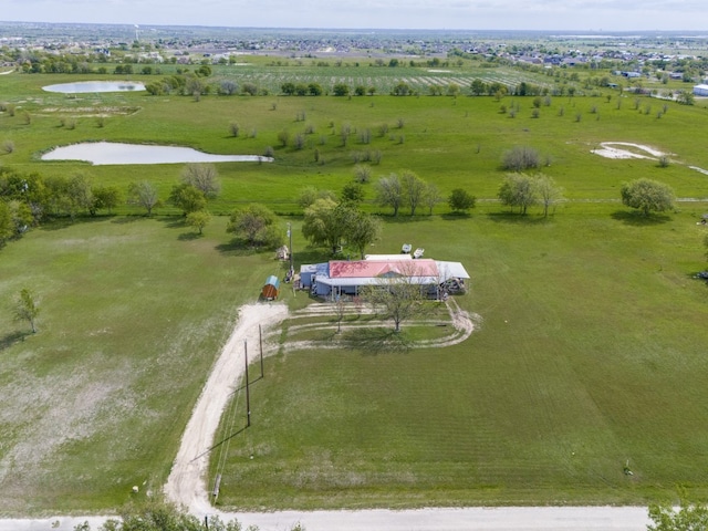 birds eye view of property featuring a water view and a rural view