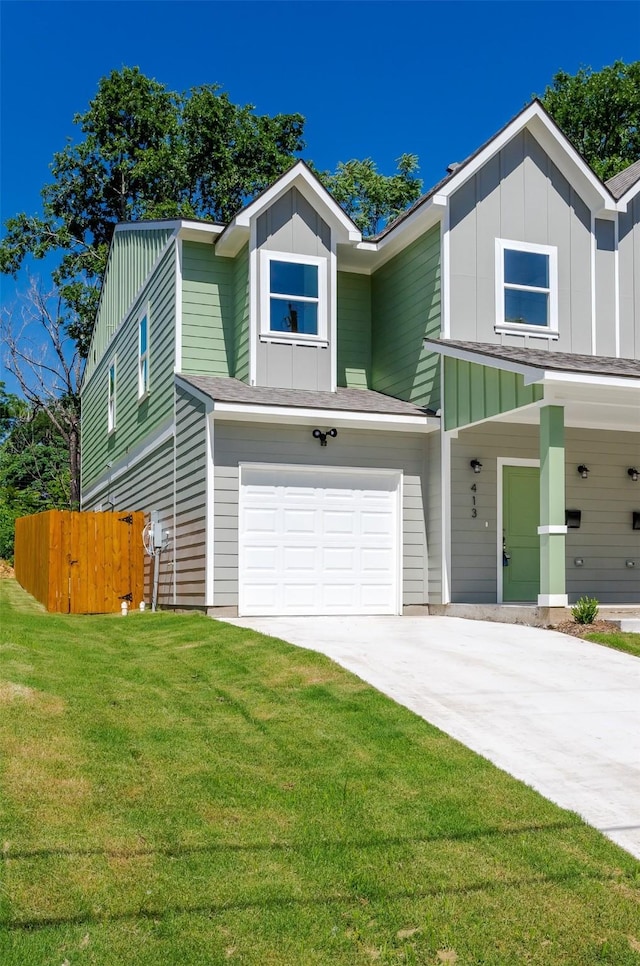 view of front of property featuring a front yard and a garage