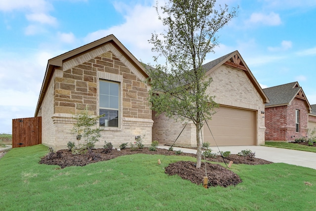 view of front of property with a garage and a front lawn