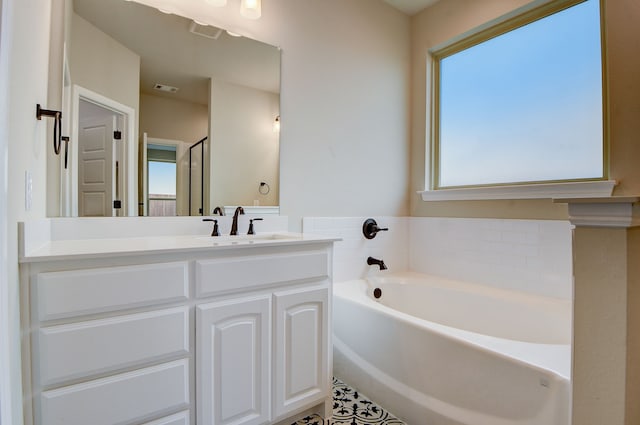 bathroom with vanity and a tub