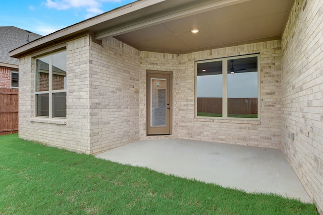 doorway to property featuring a yard and a patio area