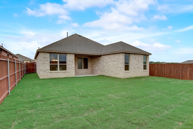 back of property with a lawn and a patio area