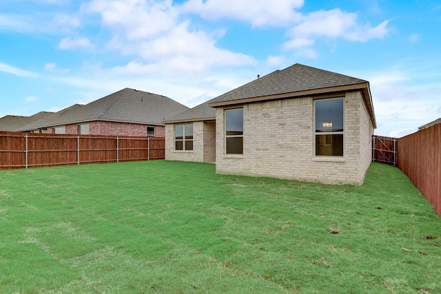 rear view of house with a yard