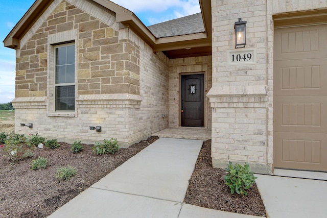 doorway to property with a garage