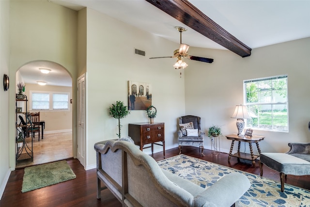 living room with beamed ceiling, ceiling fan, and dark wood-type flooring