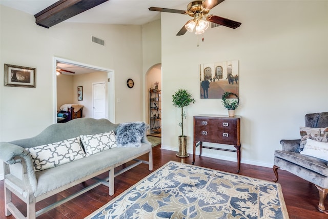 living room featuring beam ceiling, dark hardwood / wood-style floors, and ceiling fan