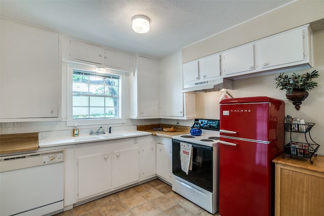 kitchen with white cabinets, custom range hood, white appliances, and light tile floors