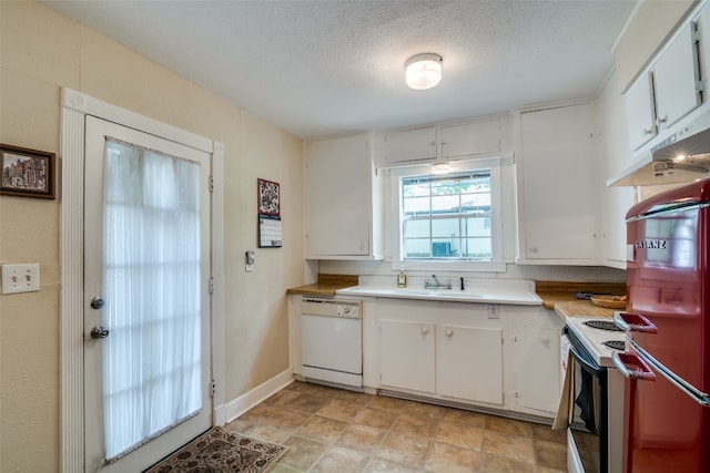 kitchen with light tile flooring, white cabinets, and white appliances