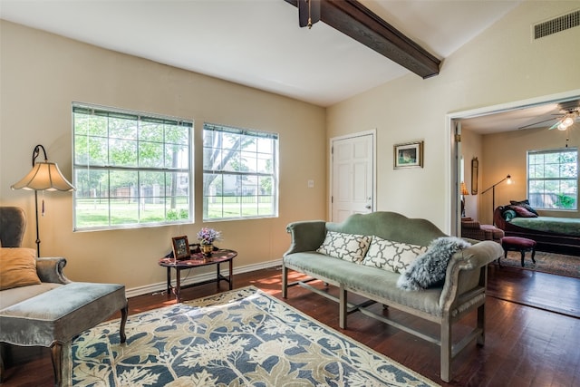 living room featuring dark hardwood / wood-style floors, ceiling fan, and lofted ceiling with beams