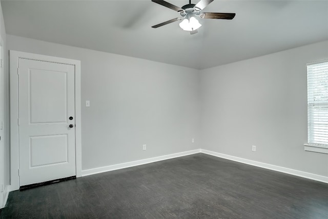 empty room featuring ceiling fan and dark hardwood / wood-style flooring