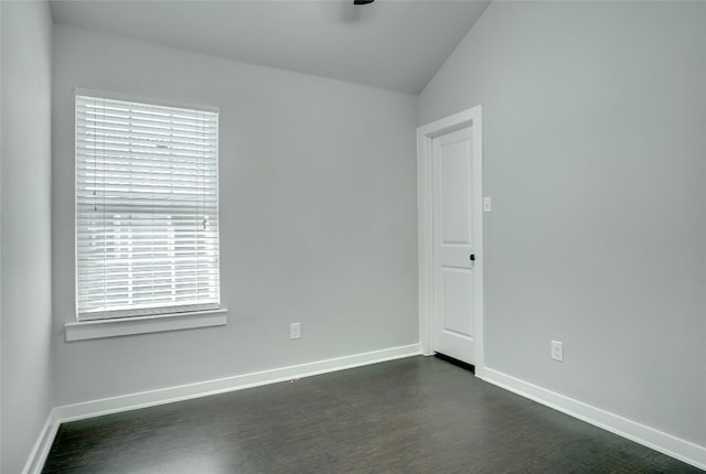 empty room with lofted ceiling and dark hardwood / wood-style floors