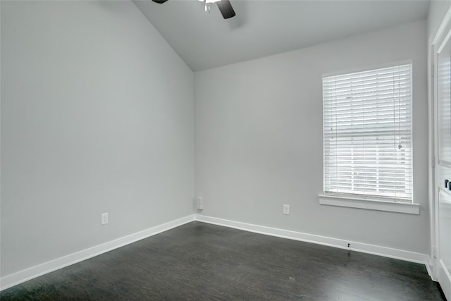 empty room featuring vaulted ceiling, dark hardwood / wood-style flooring, and ceiling fan