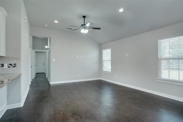 empty room with dark hardwood / wood-style flooring, ceiling fan, and lofted ceiling