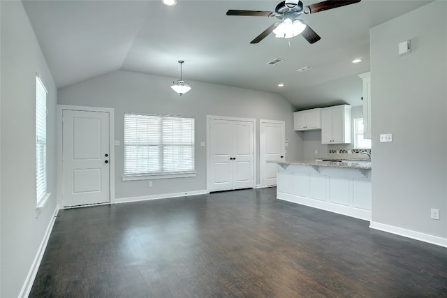 unfurnished living room with vaulted ceiling, ceiling fan, and dark hardwood / wood-style flooring