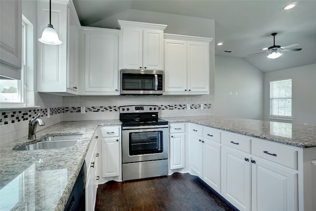 kitchen featuring ceiling fan, dark hardwood / wood-style flooring, appliances with stainless steel finishes, white cabinetry, and lofted ceiling