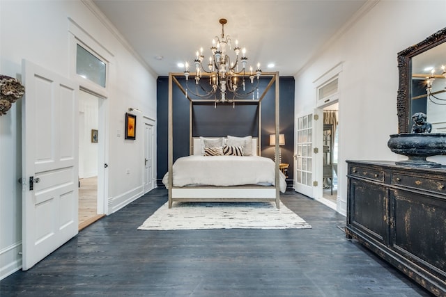 bedroom with dark hardwood / wood-style floors, crown molding, and an inviting chandelier