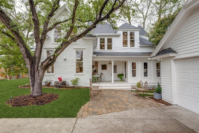 view of front of home with a front yard and a garage