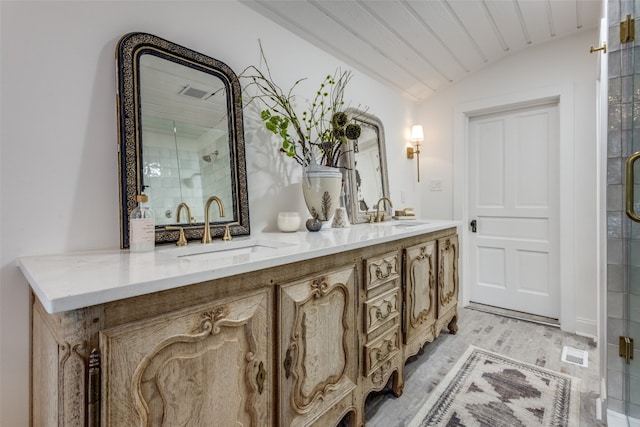 bathroom featuring vaulted ceiling with beams, dual sinks, large vanity, and walk in shower