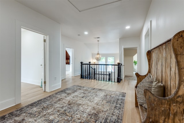 interior space featuring light hardwood / wood-style floors and an inviting chandelier