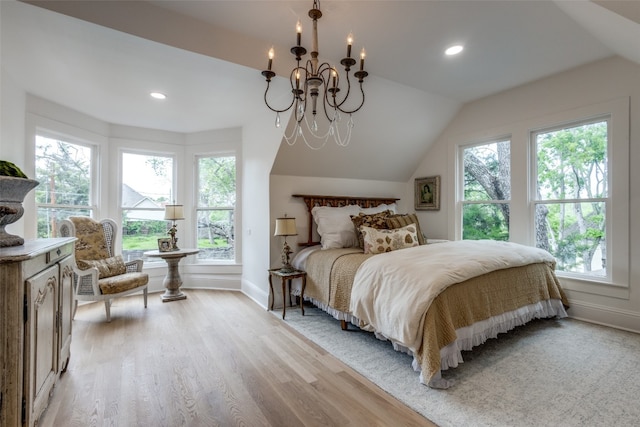 bedroom featuring vaulted ceiling, a notable chandelier, and light wood-type flooring