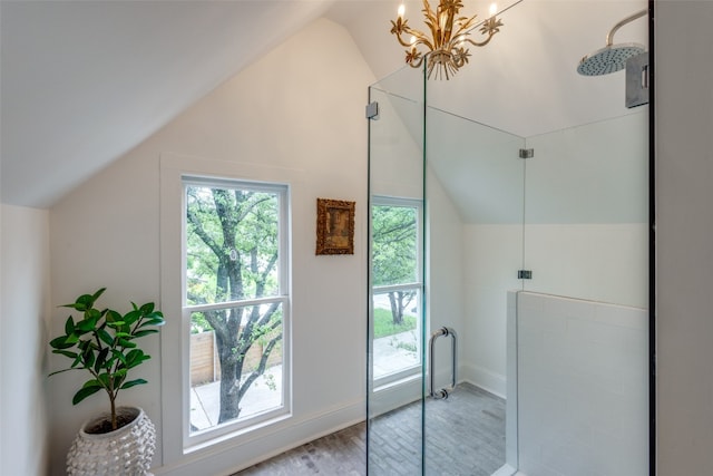 interior space with vaulted ceiling, light wood-type flooring, and a notable chandelier