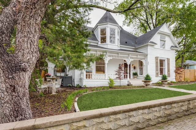 victorian house featuring a front yard and covered porch