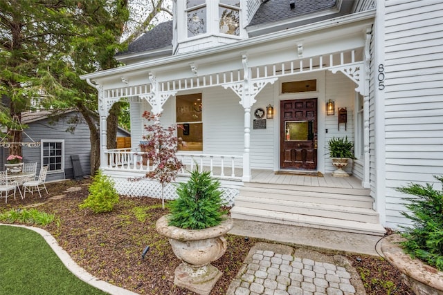 view of exterior entry featuring a porch