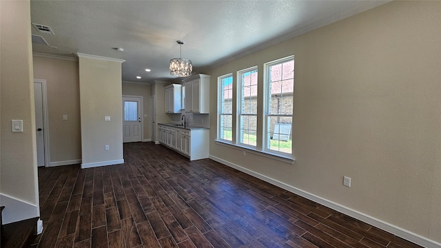 kitchen featuring a notable chandelier, white cabinetry, sink, and dark hardwood / wood-style floors