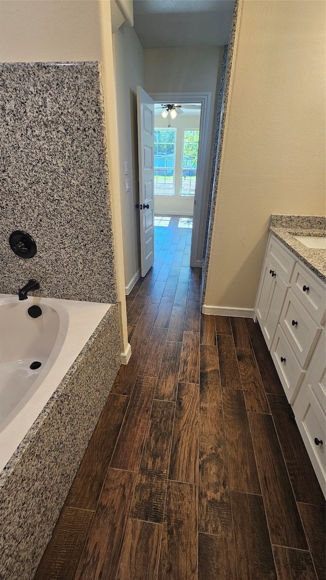 bathroom featuring wood-type flooring, vanity, and ceiling fan