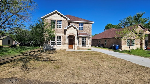 view of property featuring a front lawn