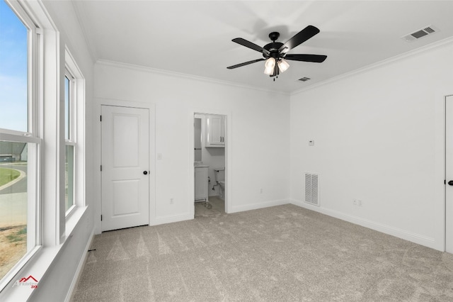 unfurnished bedroom with light colored carpet, ceiling fan, multiple windows, and crown molding