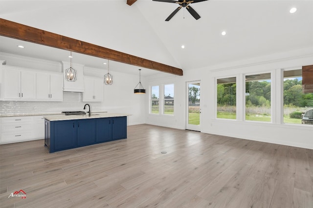 kitchen with light hardwood / wood-style floors, decorative light fixtures, and white cabinets