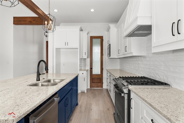 kitchen featuring light stone counters, tasteful backsplash, white cabinetry, stainless steel appliances, and sink