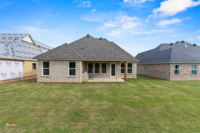 rear view of house featuring a yard and a patio