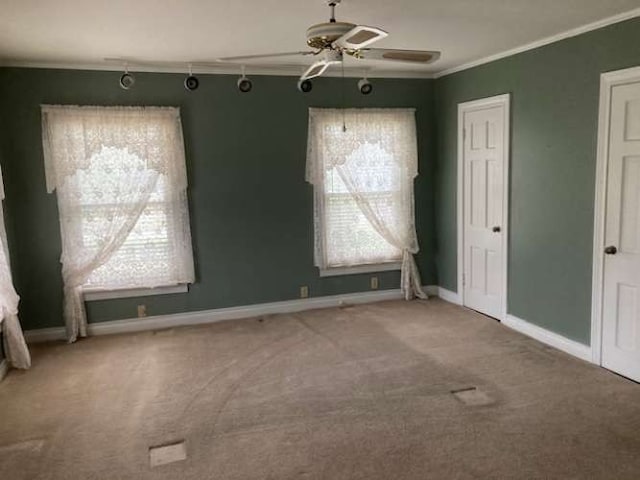 unfurnished room featuring light carpet, crown molding, and ceiling fan