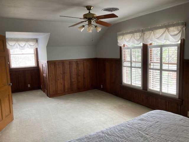 additional living space featuring ceiling fan, light carpet, and vaulted ceiling