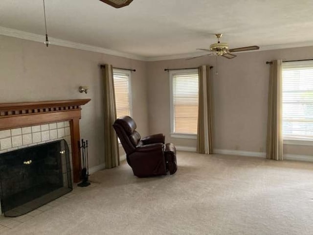 sitting room with light colored carpet, ceiling fan, a tile fireplace, and a wealth of natural light