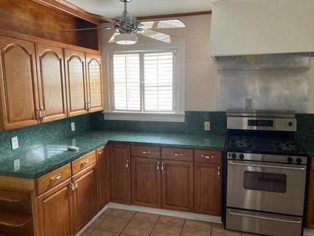 kitchen with ceiling fan, backsplash, gas stove, and light tile floors