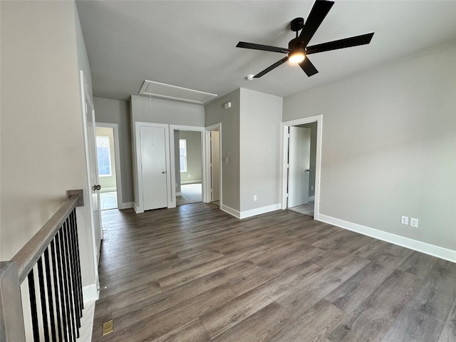 unfurnished room featuring ceiling fan and dark wood-type flooring