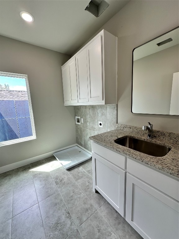 laundry room featuring hookup for a washing machine, hookup for an electric dryer, light tile floors, and sink