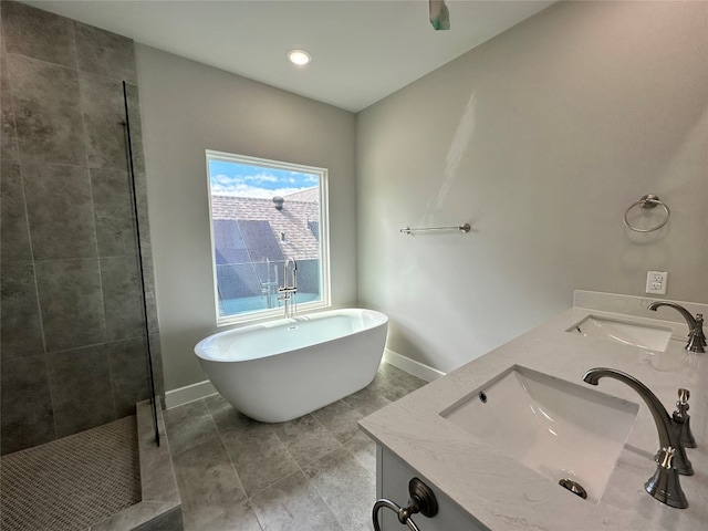 bathroom with tile floors, separate shower and tub, and dual vanity