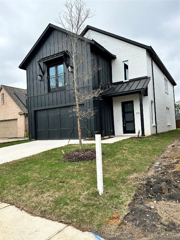 modern farmhouse with a front yard and a garage