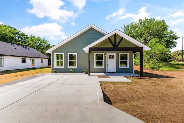 bungalow-style home with a porch and a front lawn